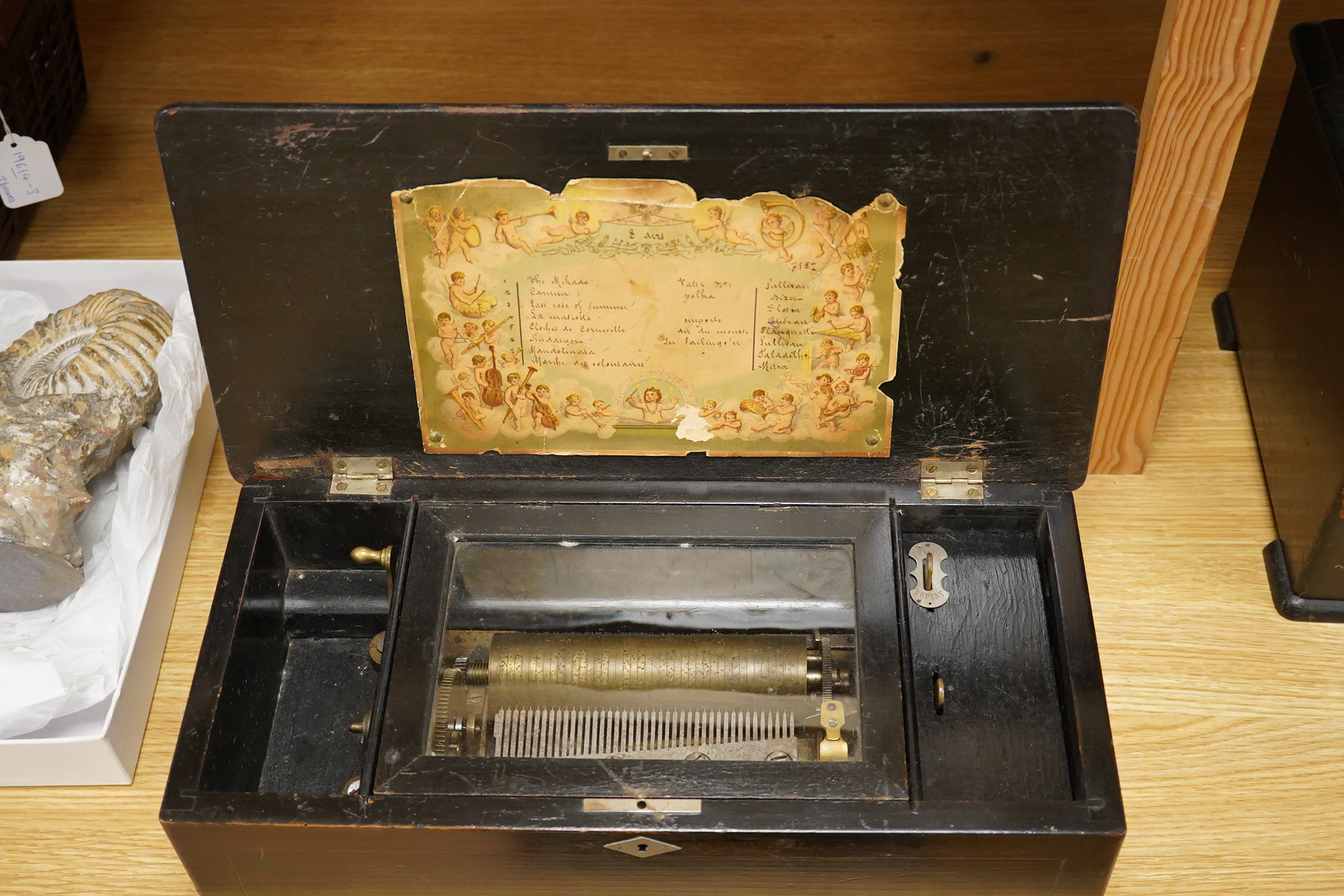 A mid-19th century inlaid and ebonised rosewood Swiss cylinder music box playing eight airs, card label to the inside of the lid listing the airs, complete with all teeth to the comb, cylinder 15.3cm long, the case; 43cm